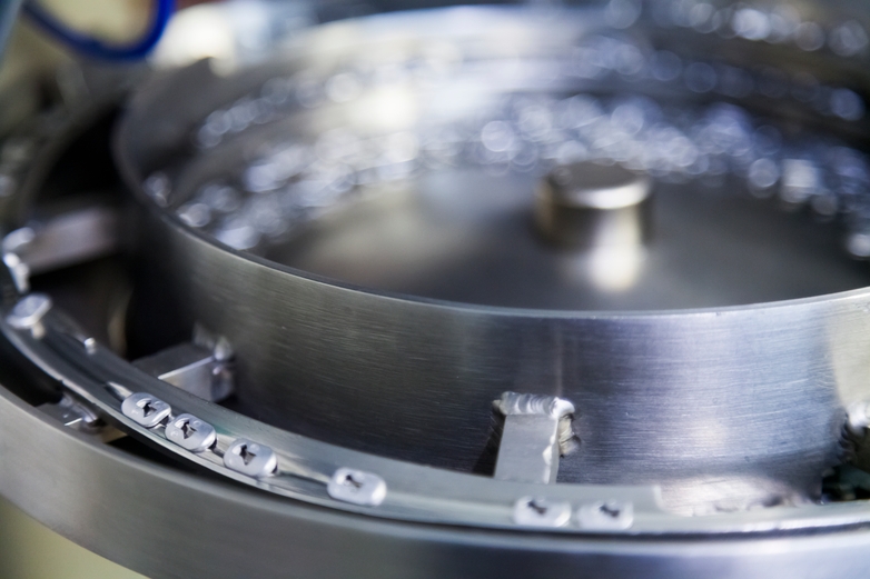 Parts moving around on a metal wheel to get sorted
