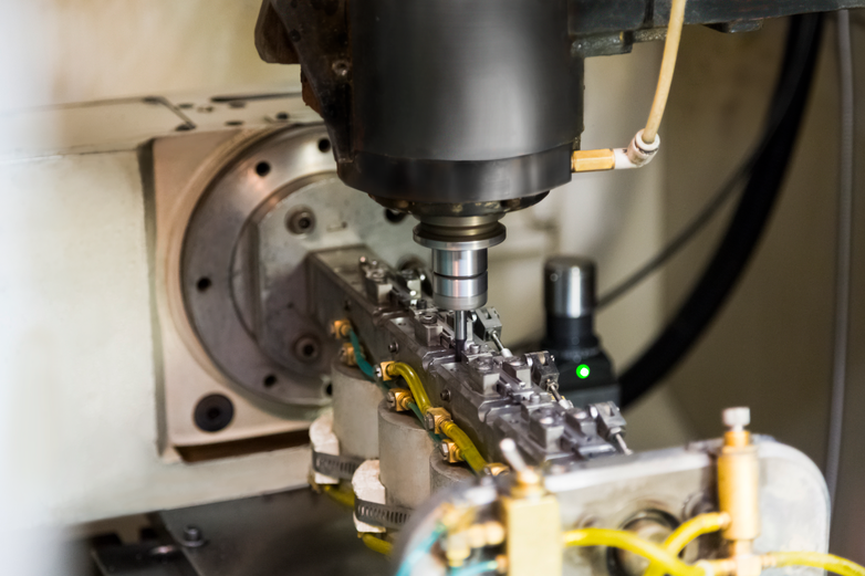 Part in a secondary operations tapping machine