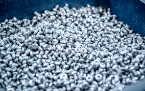 Final die cast metal parts in a bin