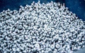 Final die cast metal parts in a bin