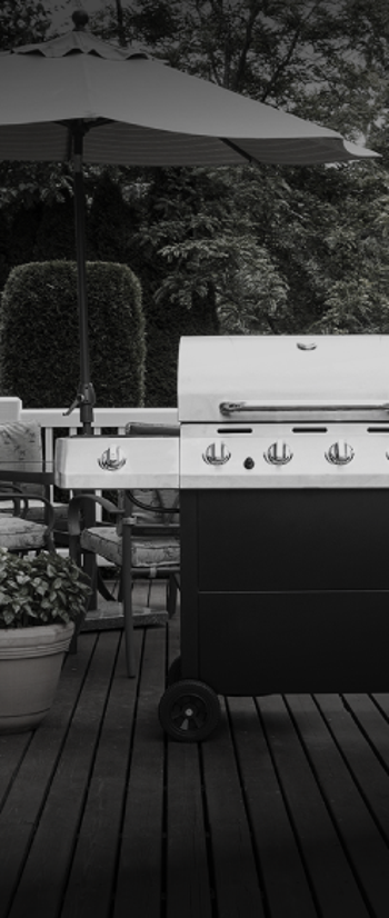 Stainless steel grill on a house deck