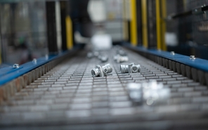 Automated conveyor belt transporting die cast parts