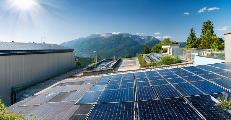 manufacturing plant with solar panels and mountains