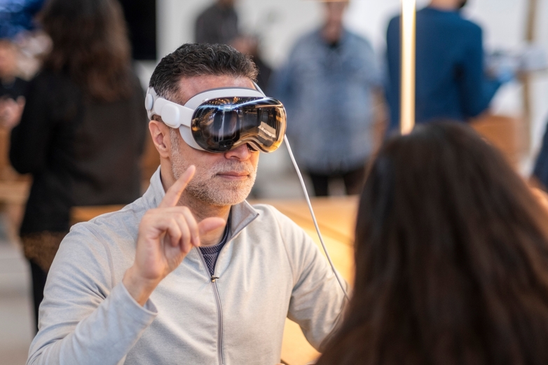 Man wearing virtual reality goggles in a consumer electronics store