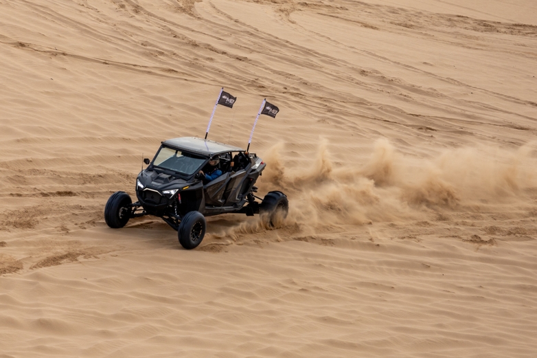 Recreational vehicle driving on a sand dune