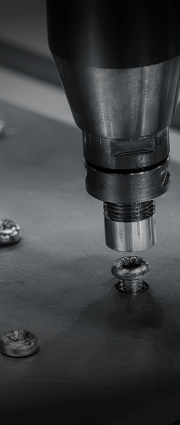 Sheet of metal with screws being drilled in