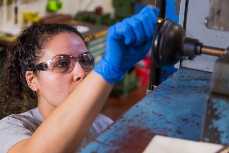An engineer operating a metal injection molding machine