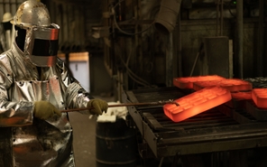 Employee moving hot investment castings