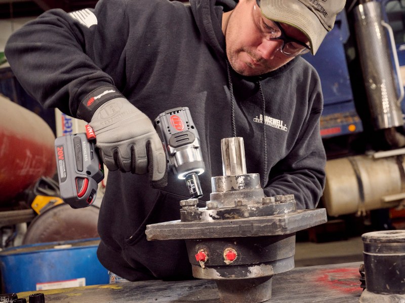 worker using w3111 impact driver