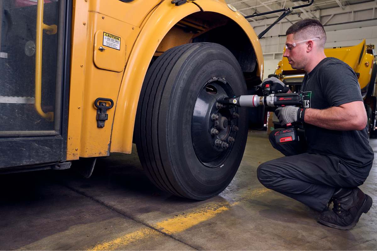 QX Series Torque Multiplier fastens lugnut on school bus wheel